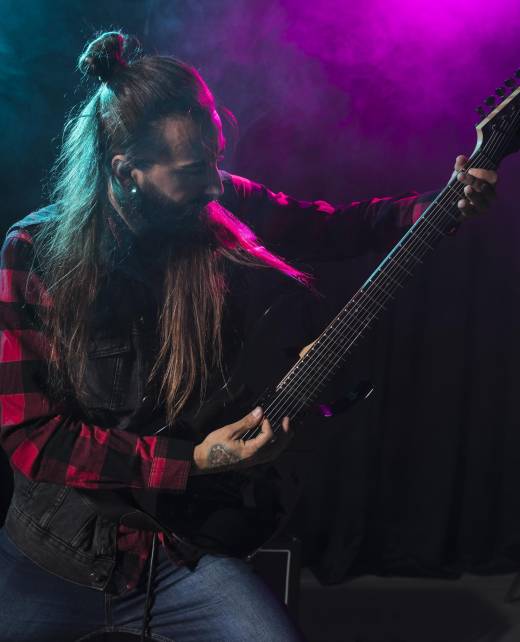 artist-playing-guitar-looking-instrument